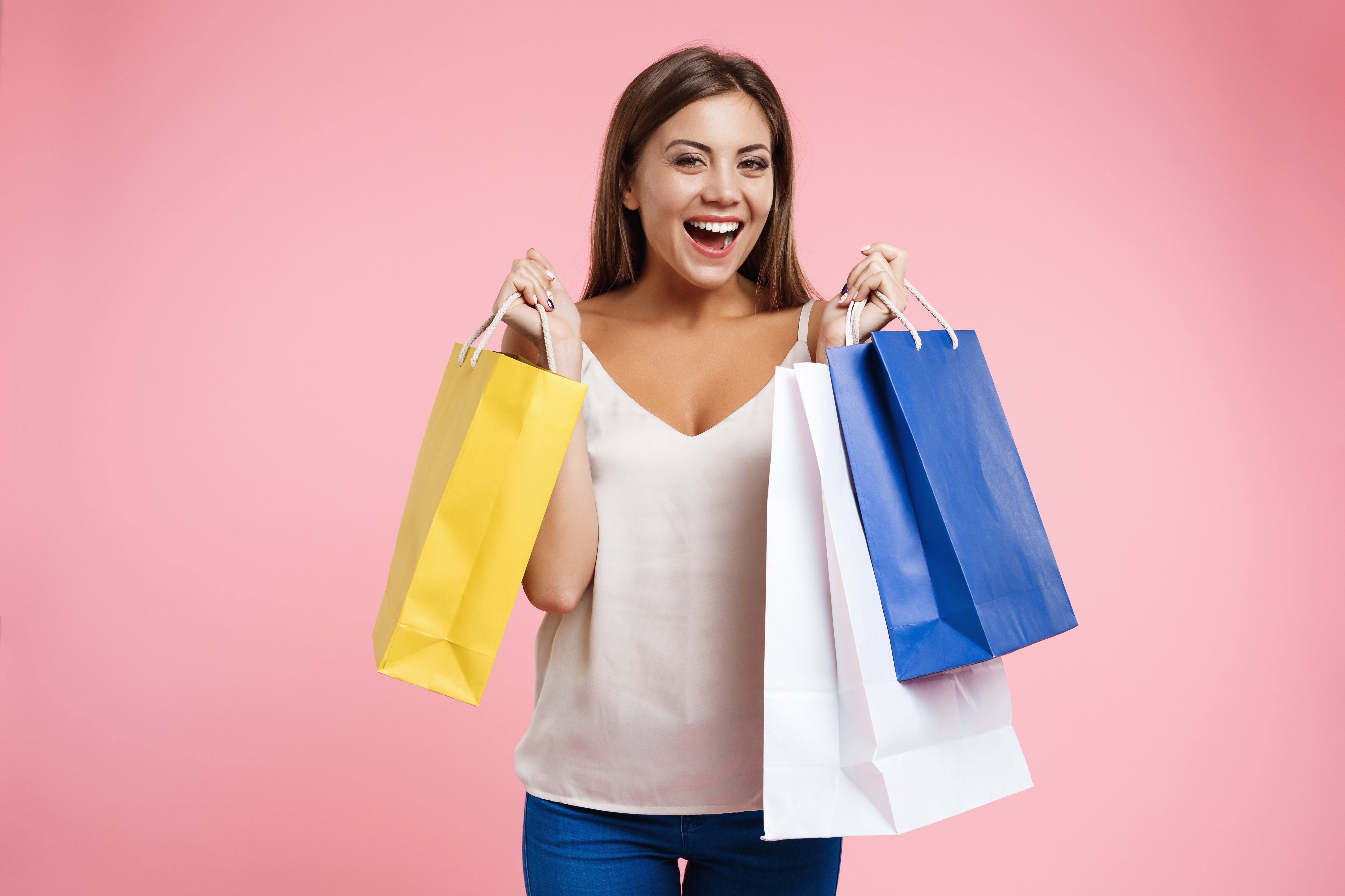 closeup-portrait-young-happy-woman-holding-bags-shopping