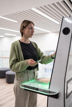 middleaged-woman-library-visitor-using-selfservice-machine-for-borrow-or-return-book
