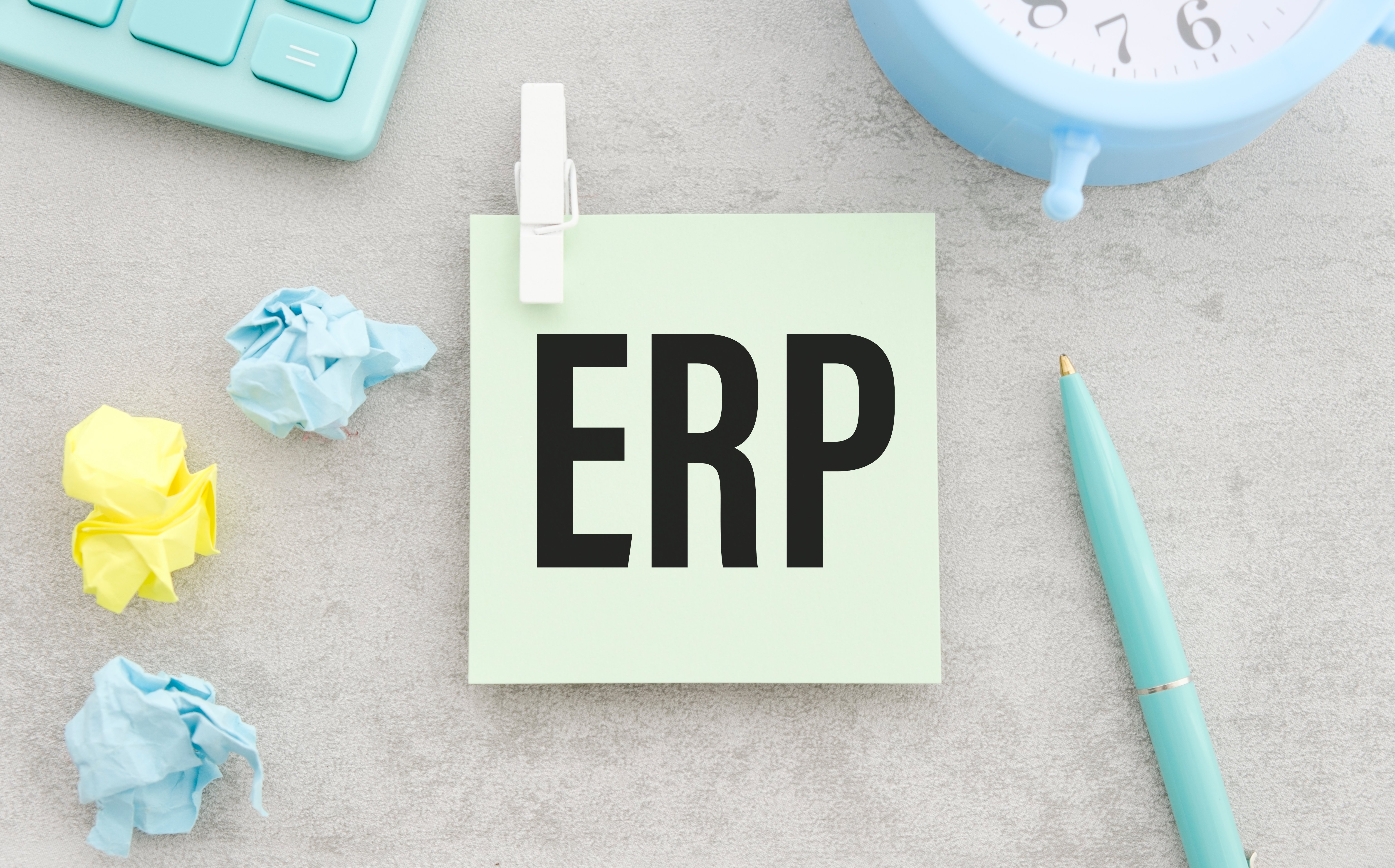 there-is-pen-between-the-blue-sticky-note-with-the-text-erp-and-the-blue-chart-business-concept-view-from-above